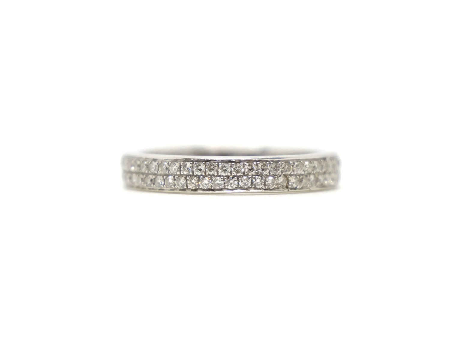 A platinum full eternity ring set with two continuous rows of round brilliant cut diamonds