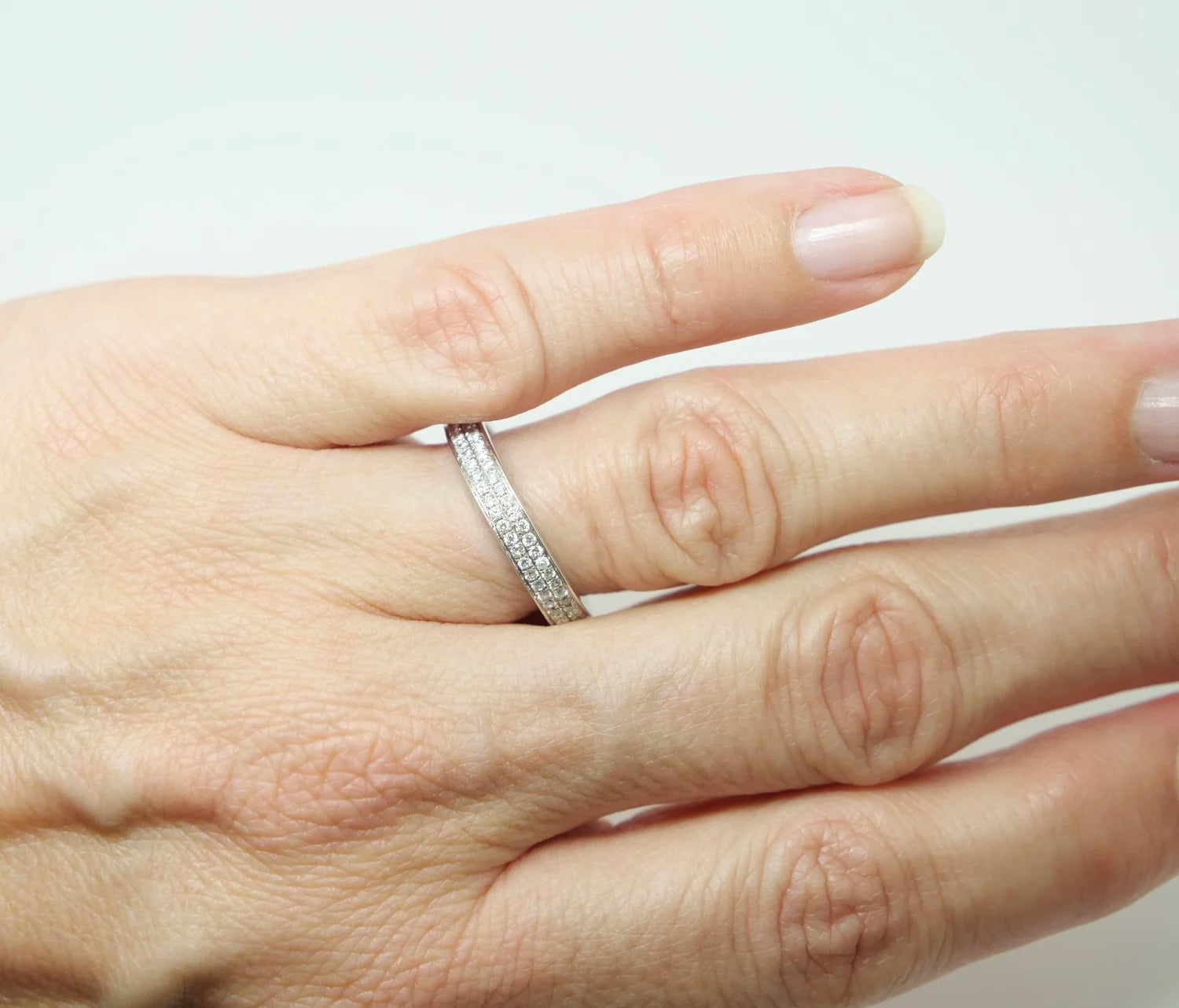 A platinum full eternity ring set with two continuous rows of round brilliant cut diamonds