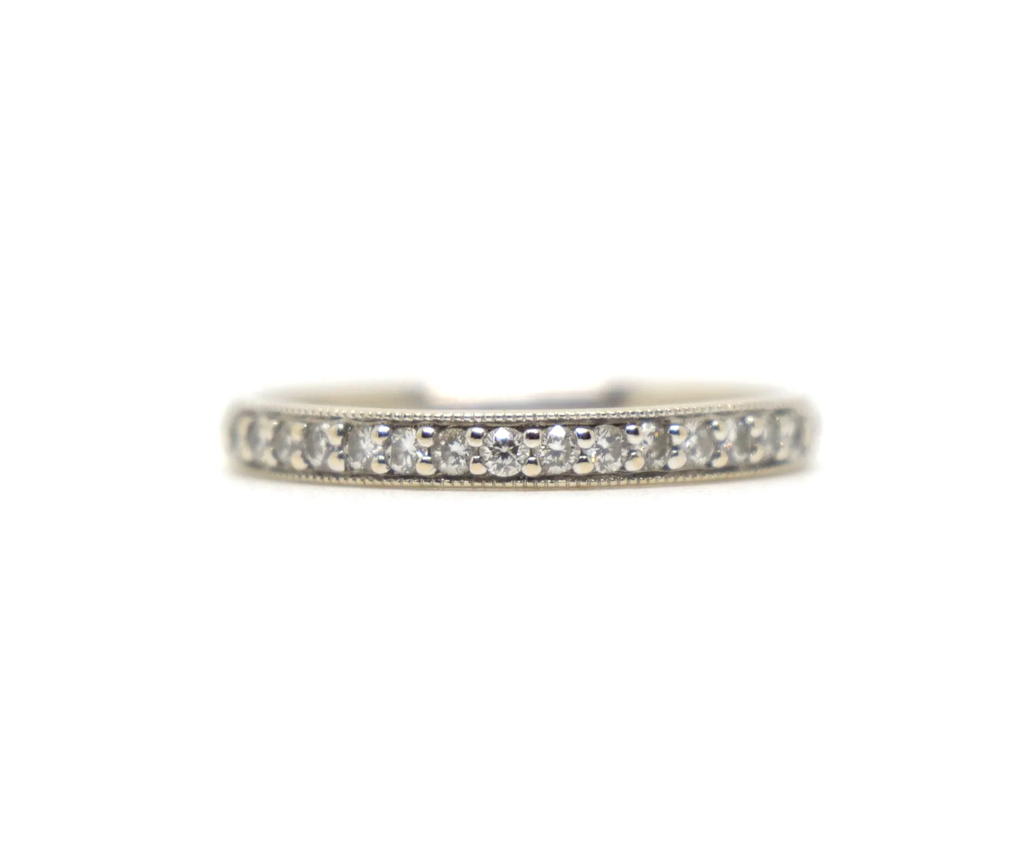 18ct white gold diamond half eternity ring, set with round brilliant cut diamonds across the top half of the band and edged with fine milgrain detail along both sides