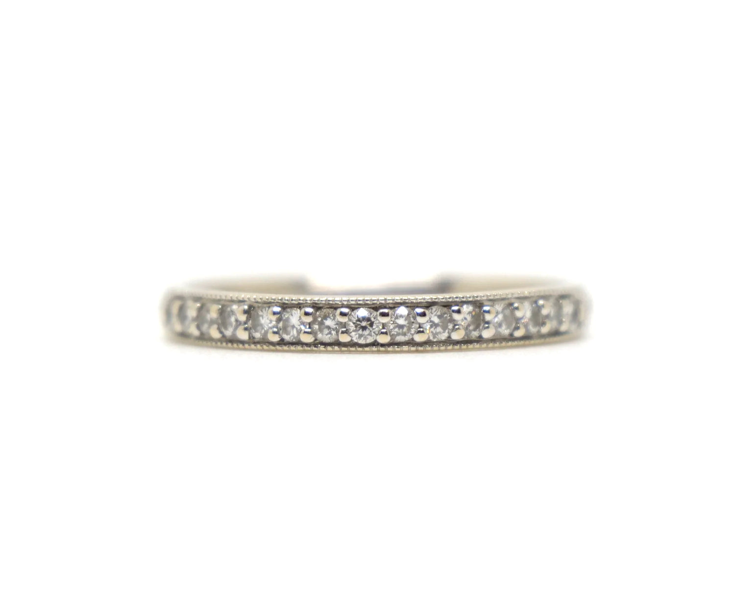 18ct white gold diamond half eternity ring, set with round brilliant cut diamonds across the top half of the band and edged with fine milgrain detail along both sides