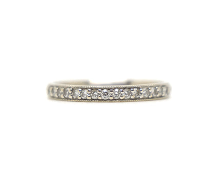 18ct white gold diamond half eternity ring, set with round brilliant cut diamonds across the top half of the band and edged with fine milgrain detail along both sides