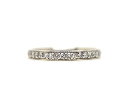 18ct white gold diamond half eternity ring, set with round brilliant cut diamonds across the top half of the band and edged with fine milgrain detail along both sides