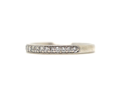 18ct white gold diamond half eternity ring, set with round brilliant cut diamonds across the top half of the band and edged with fine milgrain detail along both sides