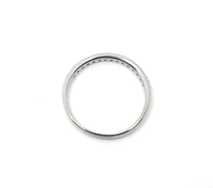 18ct white gold diamond half eternity ring, set with round brilliant cut diamonds across the top half of the band and edged with fine milgrain detail along both sides